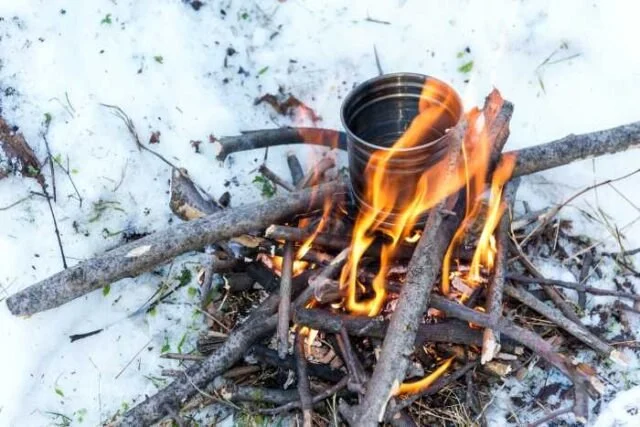 How to Use Campfire Heat to Melt Snow for Water in the Wild
