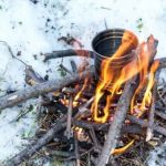 How to Use Campfire Heat to Melt Snow for Water in the Wild