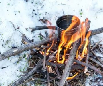 How to Use Campfire Heat to Melt Snow for Water in the Wild